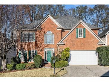 Charming brick home features lush landscaping and a well-maintained front yard at 3287 Rose Rdg, Atlanta, GA 30340