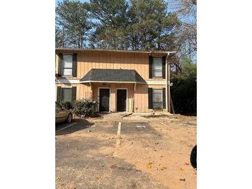 Exterior shot of a two-story townhouse featuring a well-maintained entrance and designated parking at 2340 Beaver Ruin Rd, Norcross, GA 30071