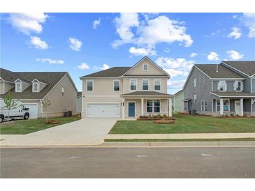 Charming two-story home with manicured lawn, attached garage, and welcoming blue front door at 537 Teversham Dr, Mcdonough, GA 30253