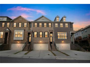 Charming multi-story townhomes with brick facades, private garages, and inviting staircases at 4121 Townsend Ln, Atlanta, GA 30346