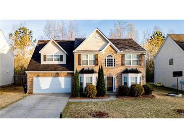 Charming two-story home featuring a stone facade, a two-car garage, and well-maintained landscaping at 4033 Roxberry Hill Ln, Buford, GA 30518