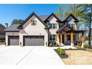 Beautiful two-story home with a three-car garage, brick facade, and welcoming front porch at 1930 Collins Hill Rd, Lawrenceville, GA 30043