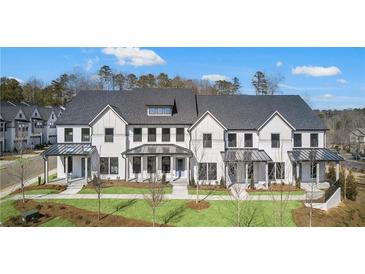 Beautifully designed modern farmhouse style townhomes with manicured lawns and tasteful landscaping at 104 Briargate Dr, Johns Creek, GA 30097