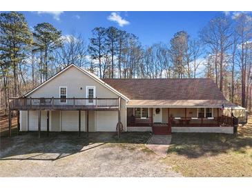 Charming home with a spacious front porch, upper deck, and a welcoming facade at 998 Sisley Trl, White, GA 30184