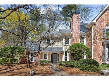 Charming two-story traditional home with brick accents, a well-manicured front yard, and a welcoming entrance at 165 River Ridge Ln, Roswell, GA 30075