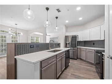 Modern kitchen with stainless steel appliances, gray cabinets and quartz countertops at 1955 Nocturne Dr # 3301, Alpharetta, GA 30009
