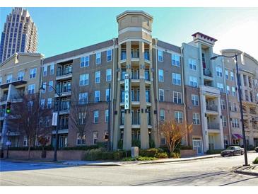 Beautiful four-story condo building featuring a tower and individual balconies on a sunny day at 390 17Th St # 2059, Atlanta, GA 30363
