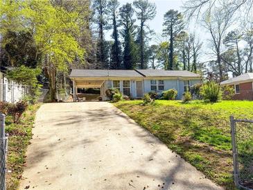 Charming single-story home with a well-maintained front yard and a convenient covered carport at 2985 Catalina Dr, Decatur, GA 30032