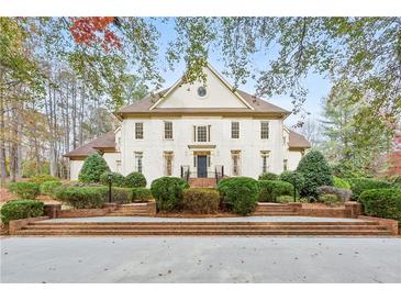 Stunning two-story home with brick exterior, manicured landscaping, and a grand entrance, exuding curb appeal at 540 Saint James Pl, Marietta, GA 30064