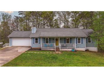 Charming single Gathering home with blue siding, front porch, and attached two-car garage at 1074 Whooping Creek Rd, Carrollton, GA 30116