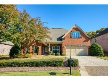 Charming single-story brick home featuring a manicured lawn, two-car garage, and well-maintained landscaping at 4540 Brighton View Trl, Cumming, GA 30040