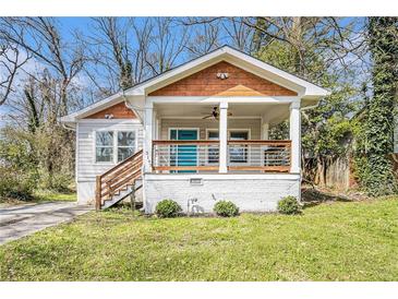 Charming bungalow with a welcoming front porch, wood detail, and manicured lawn at 3197 Church St, Atlanta, GA 30344