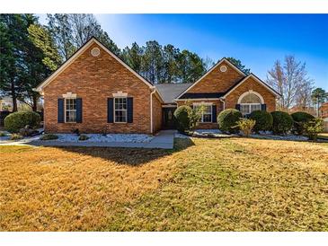 Charming brick home with manicured front yard and dark shutters at 409 Hunting Ridge Way, Ellenwood, GA 30294