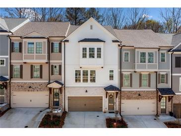 Beautiful three-story townhomes with brick accents and attached garages at 234 Retreat Ln, Canton, GA 30114