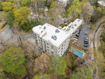 An aerial view shows the condo building with a community pool and surrounding green space at 140 Alden Nw Ave # 201, Atlanta, GA 30309