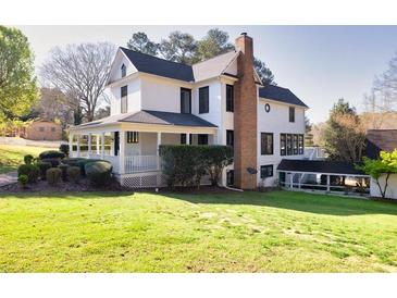 Charming two-story home features a covered porch and well-maintained landscaping at 1768 Hood Rd, Dacula, GA 30019