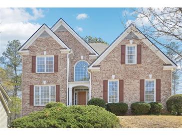 Charming brick home featuring a symmetrical design with a manicured lawn and inviting curb appeal at 3272 Creek E Trce, Powder Springs, GA 30127