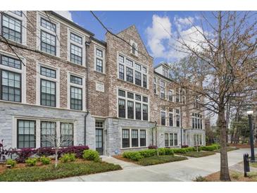 Brick townhome featuring black trim windows and manicured landscaping at 269 Devin Ne Pl, Atlanta, GA 30305