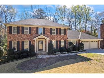 Charming brick home with well-manicured landscaping and a two-car garage at 5269 Wyntercreek Dr, Atlanta, GA 30338