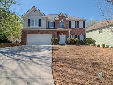 Charming two-story brick home with a well-manicured lawn, attached garage, and inviting front entrance at 1871 Shiloh Valley Nw Way, Kennesaw, GA 30144