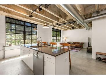Bright kitchen with stainless steel appliances, large windows, and an island with bar seating at 1065 United Ave # 208, Atlanta, GA 30316