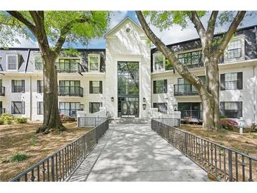 Charming condo building with lush landscaping and elegant entry, exuding curb appeal and inviting ambiance at 2303 Pine Heights Ne Dr, Atlanta, GA 30324