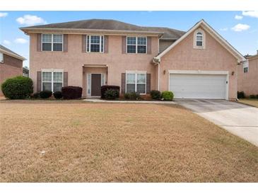 Charming two-story home featuring a two-car garage and well-maintained landscaping at 765 Rock Ln, Mcdonough, GA 30253