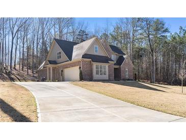 Beautiful brick two-story home with attached garage and long concrete driveway at 25 Mountain Crest Dr, Oxford, GA 30054