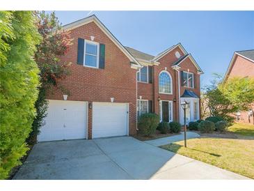 Charming brick two-story home with attached two-car garage and well-maintained landscaping at 1602 Allsworth Se Ct, Smyrna, GA 30082