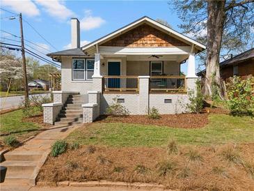 Charming bungalow with a brick facade, inviting porch, and well-manicured lawn at 1479 Hartford Sw Ave, Atlanta, GA 30310
