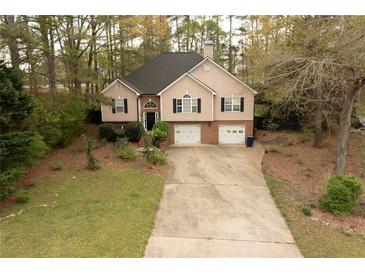 Two-story home featuring a two-car garage and a traditional facade at 2425 River Place Xing, Douglasville, GA 30135