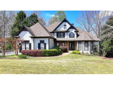Beautiful two-story home featuring manicured lawn, tasteful landscaping and traditional design elements at 4852 Jacobs Cove Pt, Buford, GA 30519