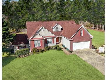 Charming brick home boasts a well-manicured lawn, red shutters, and an attached two-car garage at 3076 Harris Mill Ct, Duluth, GA 30096