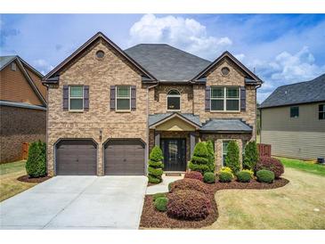Beautiful two-story brick home with a well-manicured lawn and attached two-car garage at 2580 Brittany Park Cv, Ellenwood, GA 30294