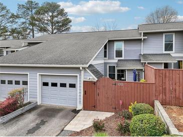 Charming townhome with a garage and a cozy fenced front yard with well-maintained landscaping at 4988 Meadow Ln, Marietta, GA 30068
