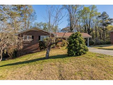 Charming one-story brick home with a well-maintained lawn and mature trees provides nice curb appeal at 761 Caron Nw Cir, Atlanta, GA 30318