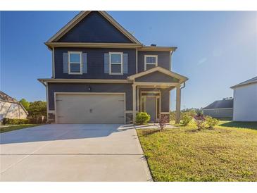 Charming two-story home featuring a two-car garage and a welcoming front porch at 417 Flowery Branch Ct, Villa Rica, GA 30180