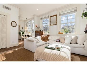 Bright living room boasts a comfortable white sectional couch and plenty of natural light at 1 S Prado Ne # 15, Atlanta, GA 30309