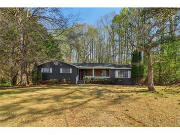 Charming single-story home with well-maintained lawn, trees, and classic exterior details at 460 Stockwood Dr, Woodstock, GA 30188
