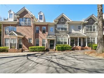 Beautiful townhome exteriors with brick and stone accents and manicured landscaping at 1119 Glenridge Pl, Atlanta, GA 30342