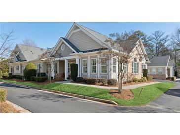 Charming single-story home featuring large windows, well-manicured lawn, and inviting curb appeal at 2565 Grapevine Cir # 103, Cumming, GA 30041