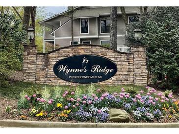 Wynne's Ridge community sign surrounded by colorful tulips and greenery, welcoming residents and guests at 1501 Wynnes Ridge Cir, Marietta, GA 30067