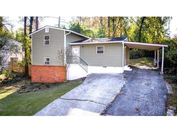 Charming home featuring brick foundation and a convenient carport at 2020 Kenwood Se Pl, Smyrna, GA 30082