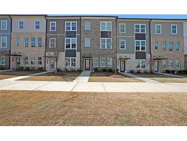 Charming townhomes in a row featuring neutral-colored brick and siding with manicured lawns and inviting entrances at 3323 Owl Creek Pkwy, Acworth, GA 30102