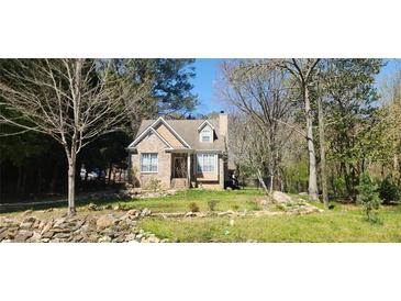 Charming brick home with landscaped front yard and inviting entrance surrounded by a lush, natural setting at 120 Johnson Nw Rd, Atlanta, GA 30318
