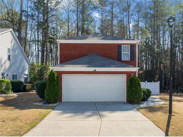 Charming brick home featuring an attached two-car garage and a well-maintained front yard at 3465 Maple Valley Dr, Cumming, GA 30040