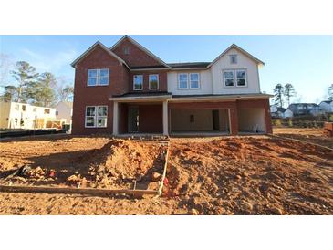 New construction two-story home featuring a two-car garage and a combination of brick and siding at 456 Maypop Ln, Woodstock, GA 30188