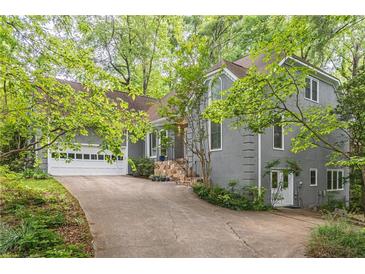 Charming two-story home featuring a spacious driveway, attached garage and beautiful mature landscaping at 363 Wilcrest Dr, Lawrenceville, GA 30044