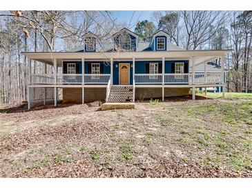Charming blue home with a welcoming front porch and classic architectural details at 2970 Oxford Rd, Atlanta, GA 30349