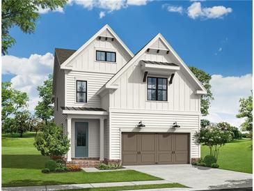 New two-story home boasts white siding, a two car garage and inviting entrance at 630 Silva St, Cumming, GA 30040